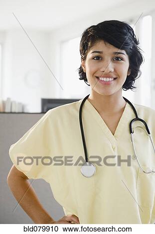 Hispanic nurse in scrubs with stethoscope View Large Photo Image Stock Image - Hispanic nurse in scrubs with stethoscope. Fotosearch