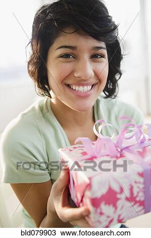 Hispanic woman holding birthday gift View Large Photo Image Stock Image - Hispanic woman holding birthday gift. Fotosearch