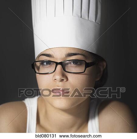 Stock Image - Hispanic woman in chef's hat and eyeglasses. Fotosearch