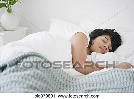 Hispanic woman sleeping in bed View Large Photo Image Stock Image - Hispanic woman sleeping in bed. Fotosearch