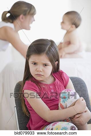 Stock Image - Mixed race girl frowning. Fotosearch