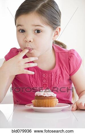 Mixed race girl licking frosting from finger View Large Photo Image Stock Photograph - Mixed race girl licking frosting from finger. Fotosearch
