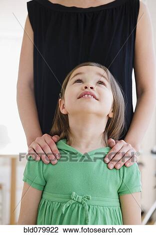 Stock Image - Mixed race girl looking at mother. Fotosearch