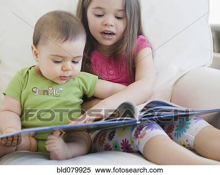 Mixed race girl reading story to brother View Large Photo Image Stock Photography - Mixed race girl reading story to brother. Fotosearch