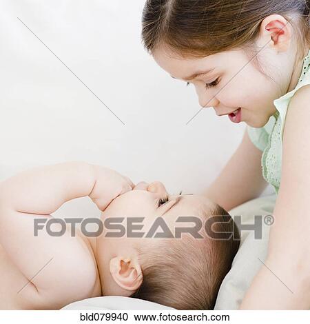 Mixed race girl talking to baby brother View Large Photo Image Stock Image - Mixed race girl talking to baby brother. Fotosearch