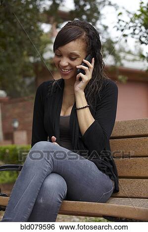 Mixed race woman talking on cell phone View Large Photo Image Stock Photograph - Mixed race woman talking on cell phone. Fotosearch