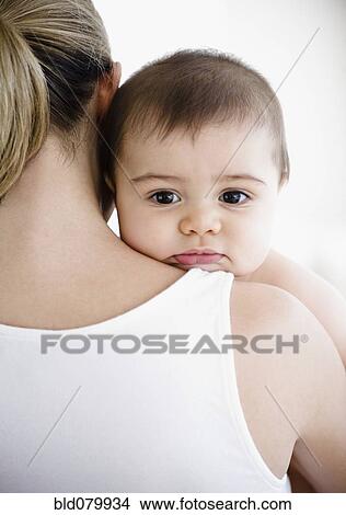 Picture - Mother holding mixed race baby boy. Fotosearch