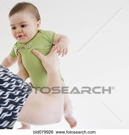 Mother lifting mixed race baby boy View Large Photo Image Stock Photograph - Mother lifting mixed race baby boy. Fotosearch