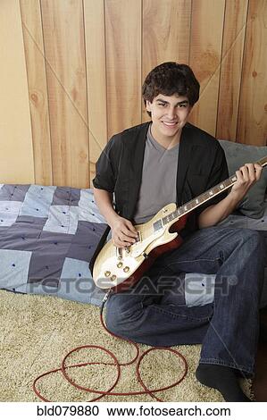 Native American teenager playing electric guitar View Large Photo Image Stock Image - Native American teenager playing electric guitar. Fotosearch