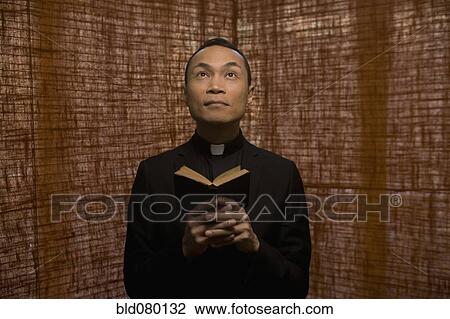 Pacific Islander priest praying View Large Photo Image Stock Image - Pacific Islander priest praying. Fotosearch