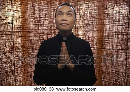 Pacific Islander priest praying View Large Photo Image Stock Image - Pacific Islander priest praying. Fotosearch