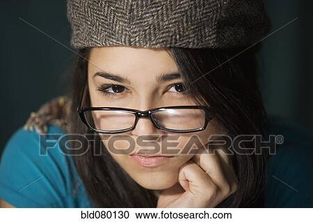 Serious Hispanic woman in cap and eyeglasses View Large Photo Image Stock Image - Serious Hispanic woman in cap and eyeglasses. Fotosearch