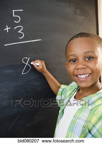 Black boy solving math problems on blackboard View Large Photo Image Stock Photo - Black boy solving math problems on blackboard. Fotosearch