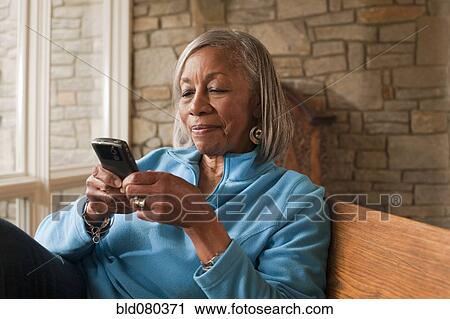 Black woman text messaging on cell phone View Large Photo Image Stock Image - Black woman text messaging on cell phone. Fotosearch