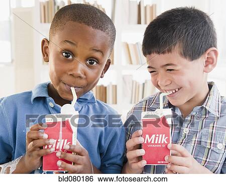 Stock Photograph - Boys drinking milk from carton. Fotosearch