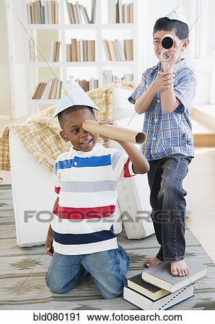 Boys playing with paper hats and cardboard telescopes View Large Photo Image Stock Image - Boys playing with paper hats and cardboard telescopes. Fotosearch