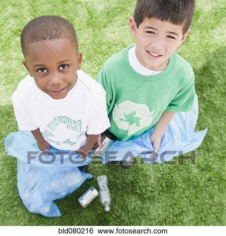 Stock Photograph - Boys with garbage bags picking up litter. Fotosearch