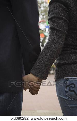 Couple holding hands View Large Photo Image Stock Image - Couple holding hands. Fotosearch