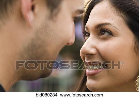 Couple smiling at each other View Large Photo Image Picture - Couple smiling at each other. Fotosearch