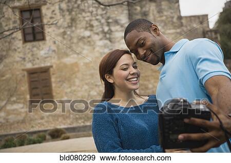 Couple taking self-portrait with digital camera View Large Photo Image Stock Photo - Couple taking self-portrait with digital camera. Fotosearch