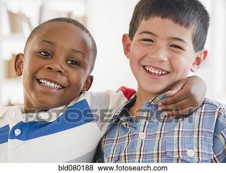 Stock Photo - Friends smiling and hugging each other. Fotosearch