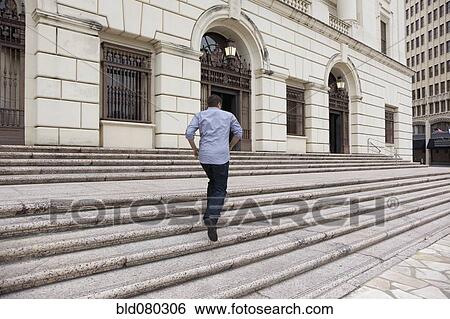 Hispanic man running up steps of urban building View Large Photo Image Stock Photograph - Hispanic man running up steps of urban building. Fotosearch