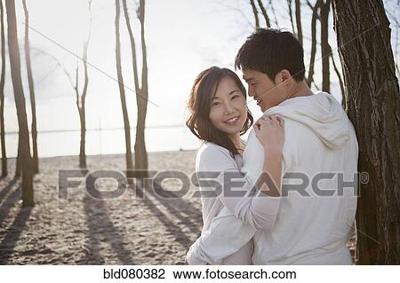 Korean couple hugging outdoors View Large Photo Image Stock Image - Korean couple hugging outdoors. Fotosearch