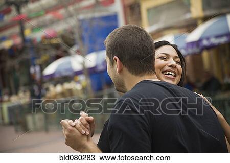 Stock Image - Laughing couple dancing outdoors. Fotosearch
