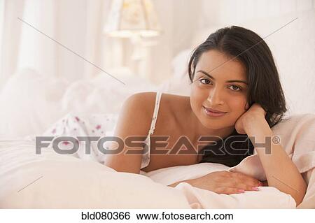 Middle Eastern woman laying in bed View Large Photo Image Stock Photograph - Middle Eastern woman laying in bed. Fotosearch