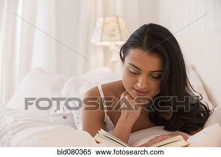 Middle Eastern woman reading in bed View Large Photo Image Stock Photography - Middle Eastern woman reading in bed. Fotosearch