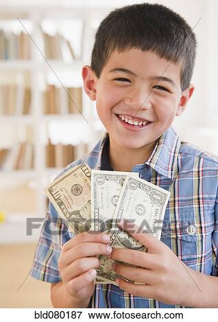 Stock Photo - Mixed race boy holding money. Fotosearch