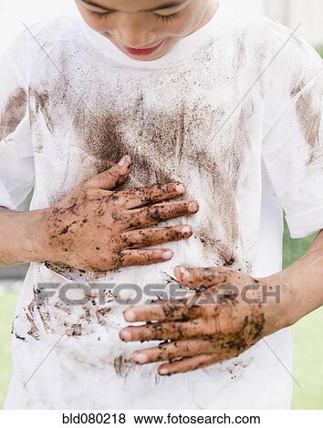 Mixed race boy wiping messy hands on shirt View Large Photo Image Stock Photo - Mixed race boy wiping messy hands on shirt. Fotosearch