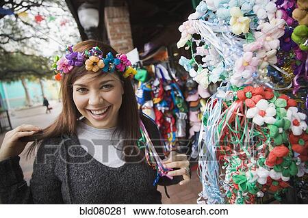 Mixed race woman trying on headdress at souvenir shop View Large Photo Image Stock Image - Mixed race woman trying on headdress at souvenir shop. Fotosearch