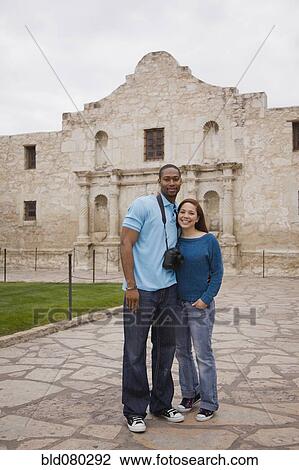 Stock Image - Smiling couple at tourist attraction. Fotosearch