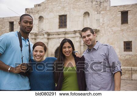 Smiling couples at tourist attraction View Large Photo Image Stock Image - Smiling couples at tourist attraction. Fotosearch