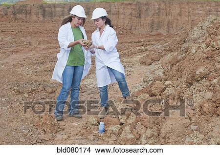 Workers analyzing rock specimen View Large Photo Image Picture - Workers analyzing rock specimen. Fotosearch