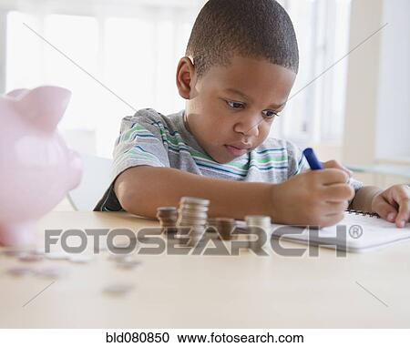 Stock Image - African American boy counting coins. Fotosearch