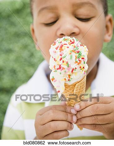 African American boy eating ice cream cone View Large Photo Image Stock Image - African American boy eating ice cream cone. Fotosearch