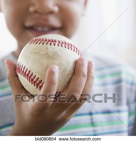 Picture - African American boy holding baseball. Fotosearch