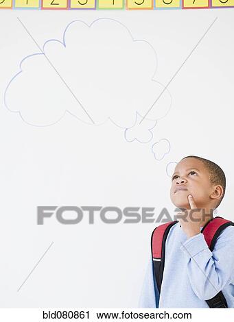 Stock Image - African American boy in school with thought bubble. Fotosearch
