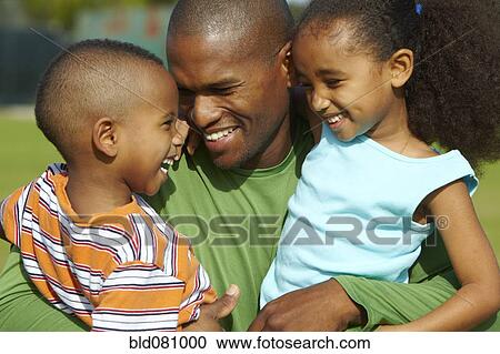 African American father hugging son and daughter View Large Photo Image Stock Image - African American father hugging son and daughter. Fotosearch