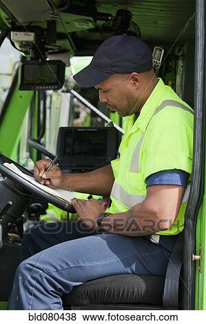 African American man in garbage truck writing on clipboard View Large Photo Image Stock Photo - African American man in garbage truck writing on clipboard. Fotosearch