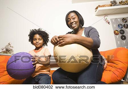 African American mother and son holding balls View Large Photo Image Stock Image - African American mother and son holding balls. Fotosearch
