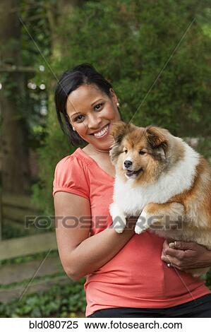 African American woman holding dog View Large Photo Image Stock Photography - African American woman holding dog. Fotosearch