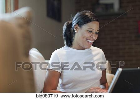 African American woman using laptop View Large Photo Image Stock Photo - African American woman using laptop. Fotosearch