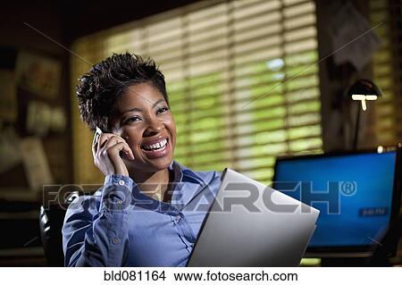 Black businesswoman in office using cell phone View Large Photo Image Picture - Black businesswoman in office using cell phone. Fotosearch