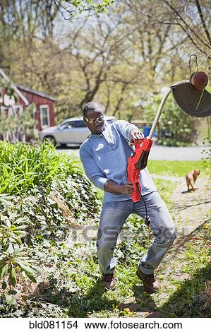 Black man struggling with weed trimmer View Large Photo Image Picture - Black man struggling with weed trimmer. Fotosearch