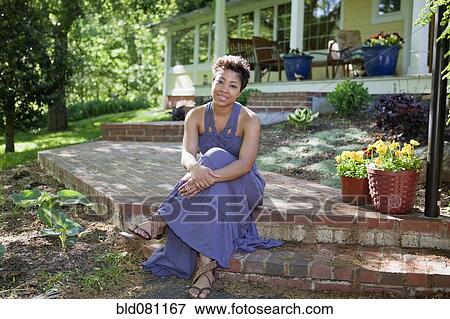 Black woman sitting on step in back yard View Large Photo Image Stock Photo - Black woman sitting on step in back yard. Fotosearch