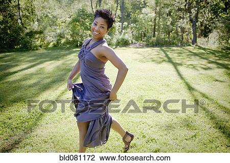 Black woman walking across lawn View Large Photo Image Stock Image - Black woman walking across lawn. Fotosearch