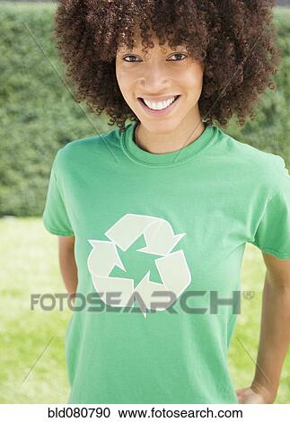 Stock Image - Black woman wearing recycling symbol t-shirt. Fotosearch